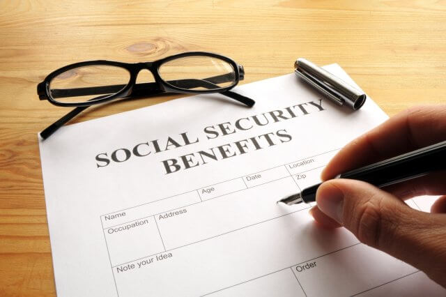 Person filling out social security benefits form