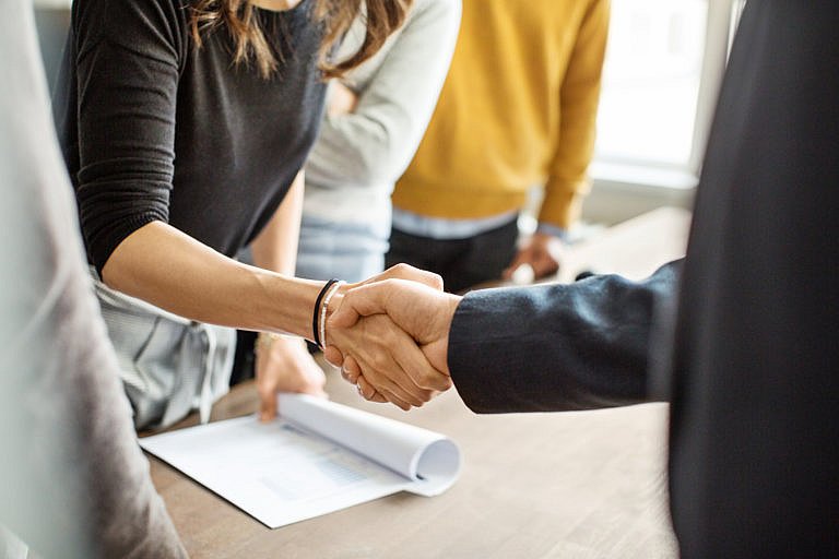 Disability attorney shaking hands with client