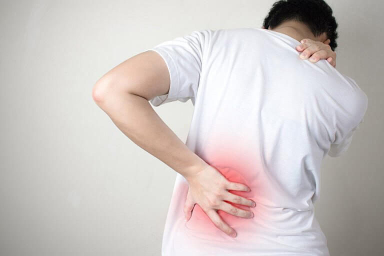 man holding back in pain