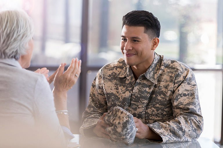 hispanic male veteran with elderly female attorney