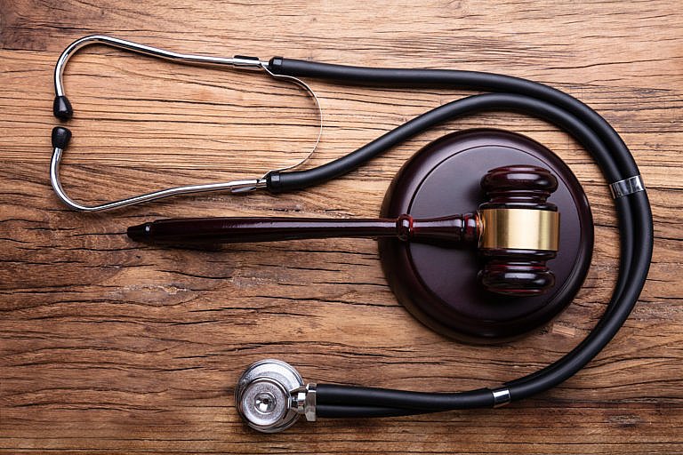 Gavel With Stethoscope Arranged On Table