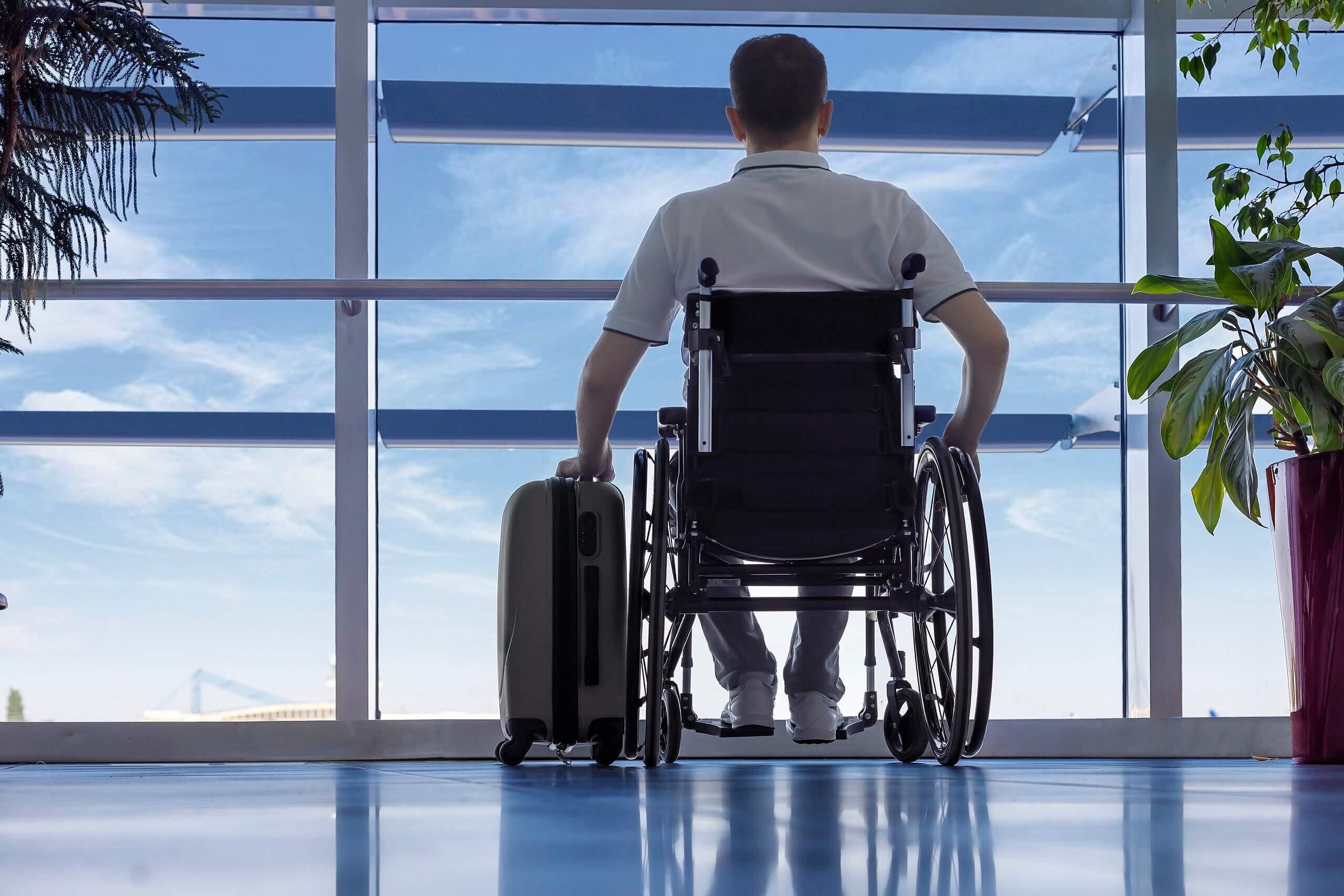 Man in wheelchair waiting in airport