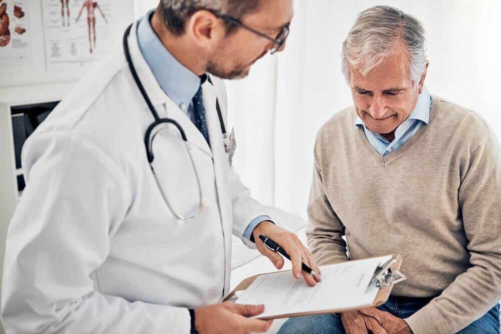 Consultation, man and doctor in office with clipboard, results and advice for health insurance.