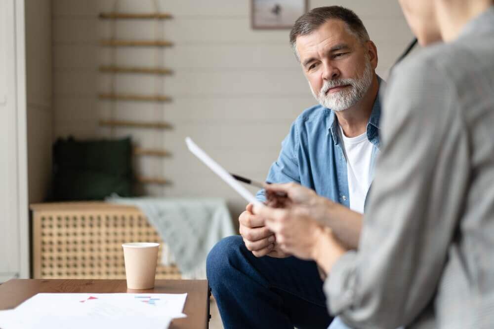 Veteran consulting with an attorney about VA disability claim paperwork and benefits assistance.
