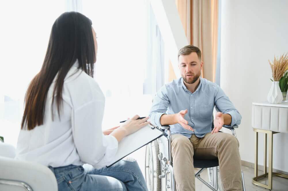 Portrait of female psychiatrist interviewing handicapped man