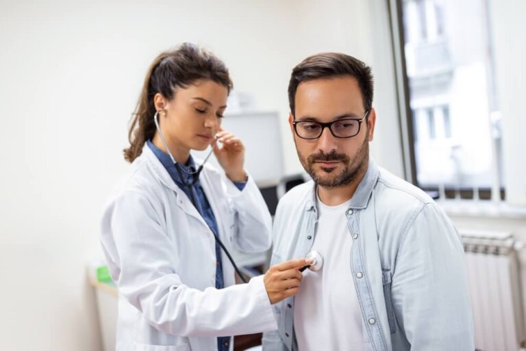 Caring Caucasian female doctor use phonendoscope examine male patient heart rate at consultation in hospital.