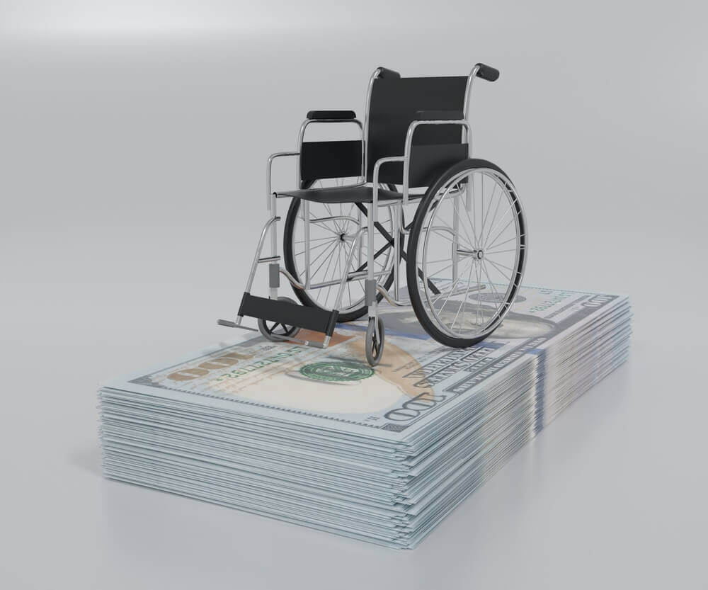 isolated wheelchair with stack of paper cash bills in 100 US dollar in the white background