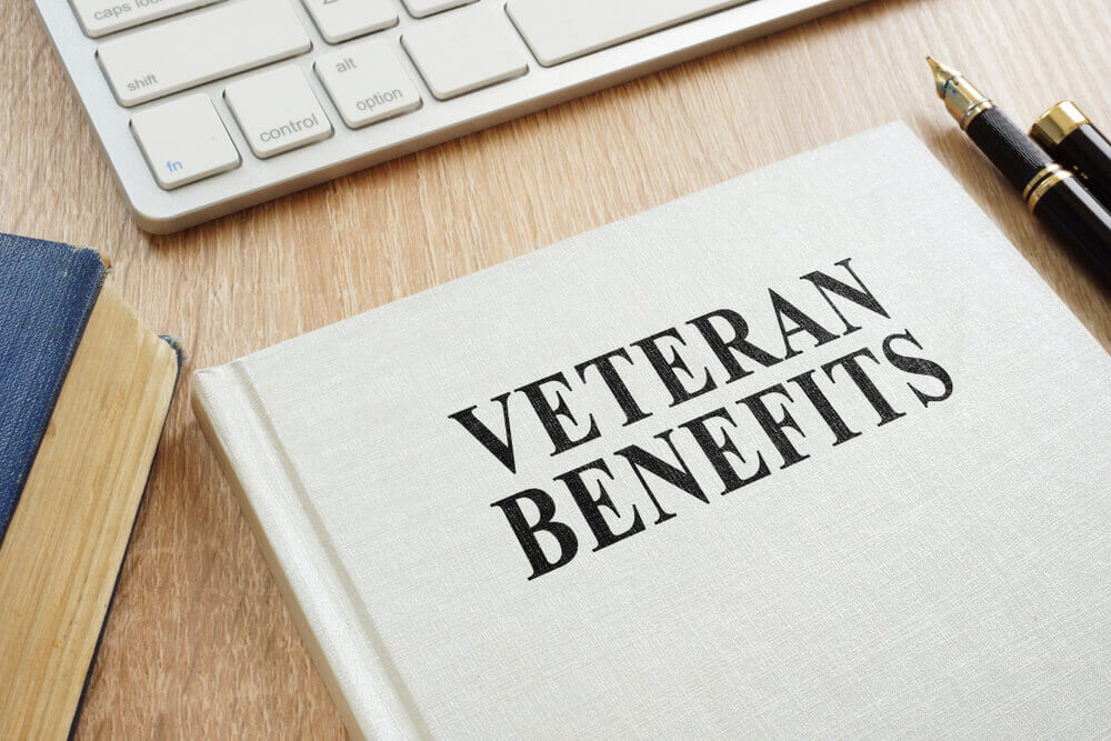 Veterans' benefits guidebook on desk, symbolizing legal support for veterans' disability, healthcare, and housing claims.