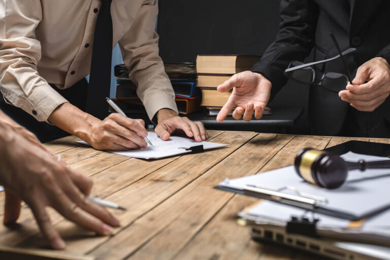 Teamwork of business lawyer meeting working hard about legal legislation in courtroom to help their customer.