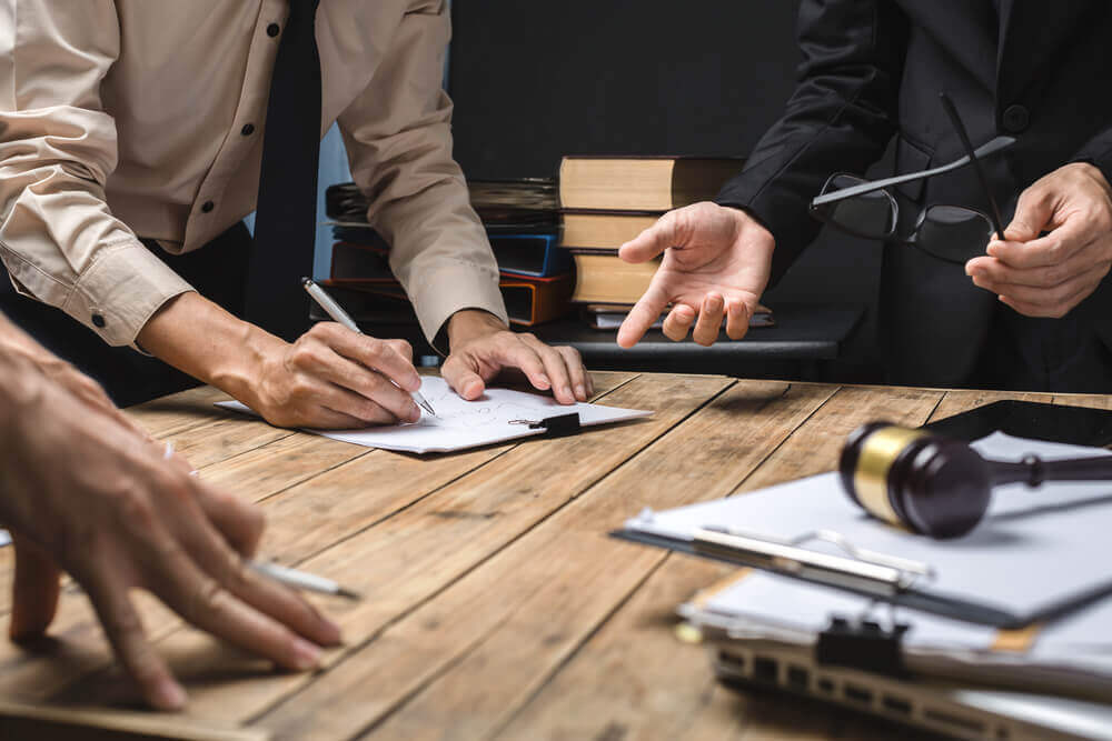 Teamwork of business lawyer meeting working hard about legal legislation in courtroom to help their customer.