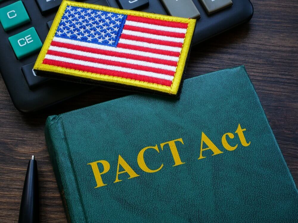 PACT Act book with American flag patch – 2025 updates impacting VA disability claims for veterans exposed to toxic substances