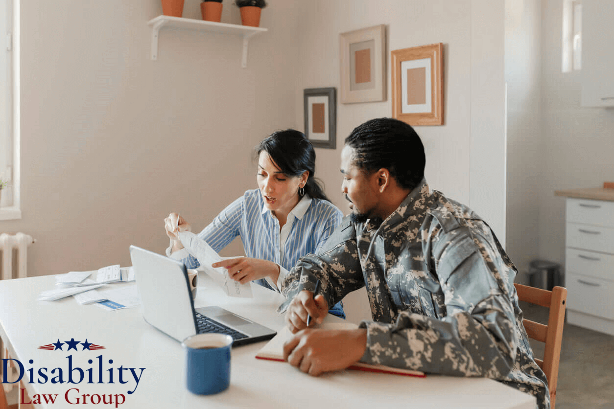 Veteran reviewing Camp Lejeune disability claim paperwork with legal assistance at home