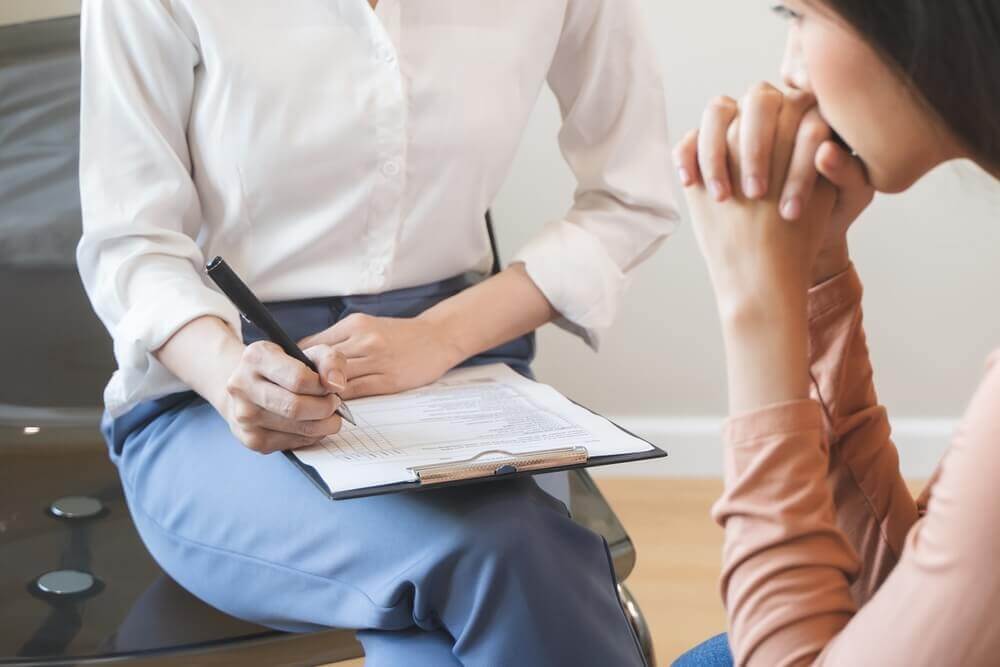 Michigan disability lawyer helping client complete Social Security Disability application for mental health benefits