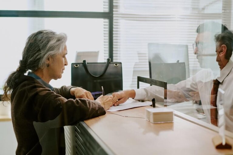Disability applicant reviewing paperwork at a Social Security office during extended 2026 SSA processing times.