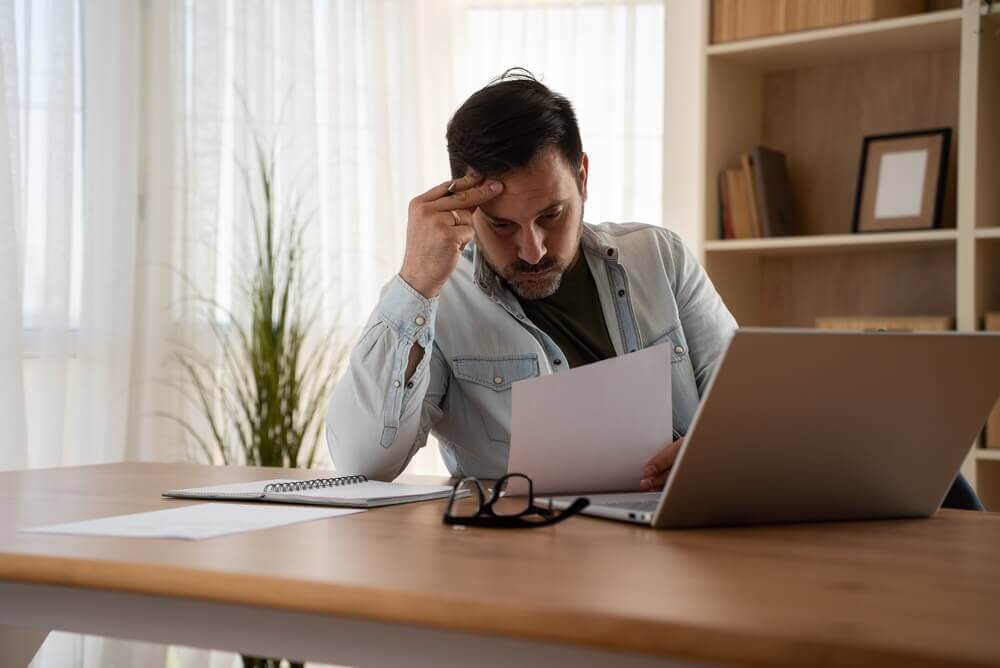 Man reviewing Social Security disability benefits paperwork at home in 2026